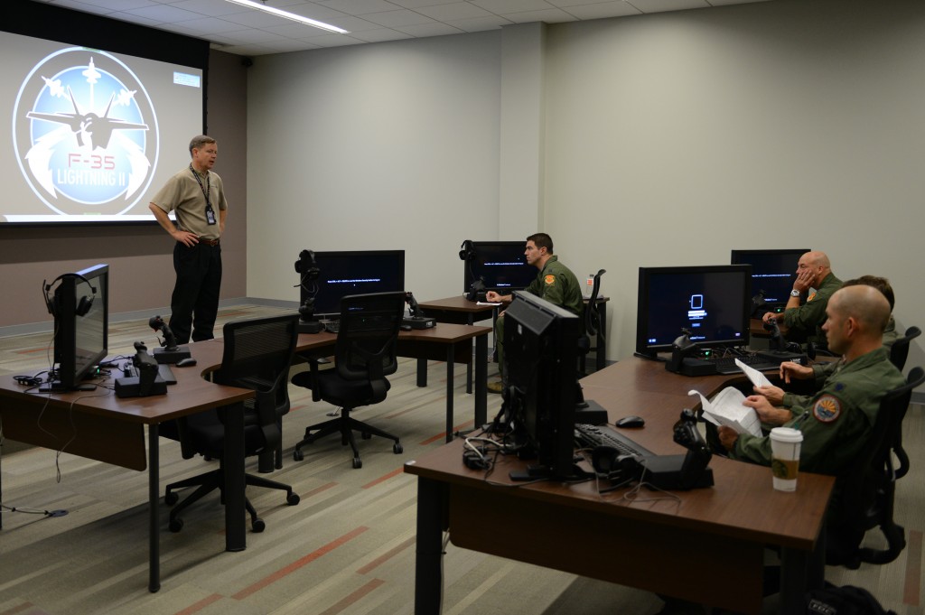 Travis Byrom, Lockheed Martin instructor pilot, gives students a morning briefing before the start of class at Luke Air Force Base, Arizona, May 5, 2015. The four students are part of the first class to train on the F-35 at Luke. Upon completion of training they will assume the role of instructors to teach future classes of F-35 students. (U.S. Air Force photo by Senior Airman James Hensley)